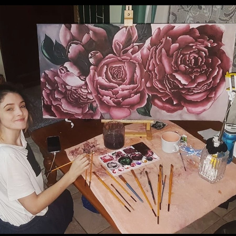 Hope painting a large canvas of burgundy roses