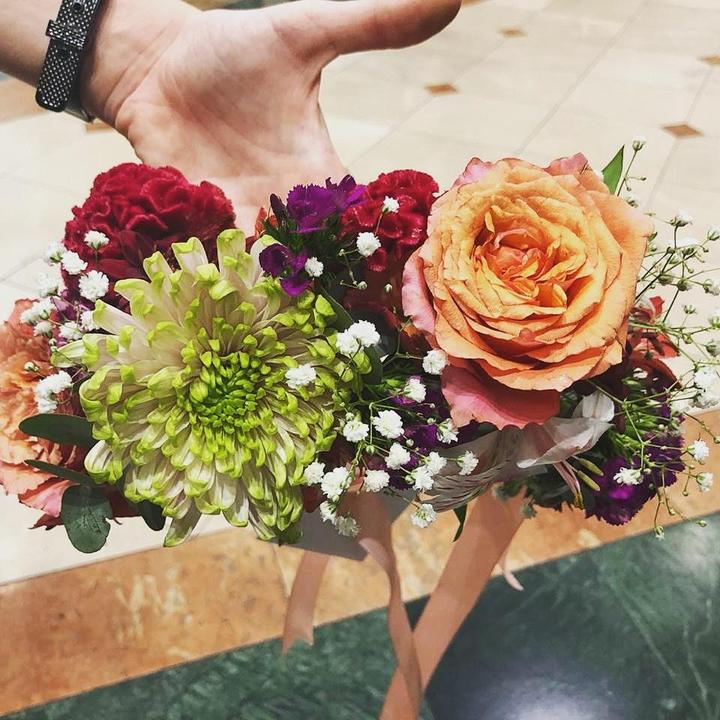 Hand-tied bouquet of peach roses and greenery