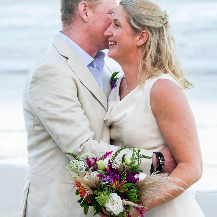 Bride and groom with a colourful bridal bouquet