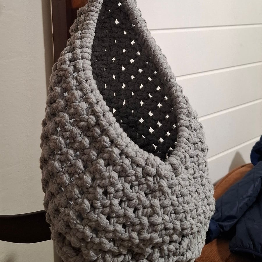 Grey macramé hanging basket on a wooden coat stand