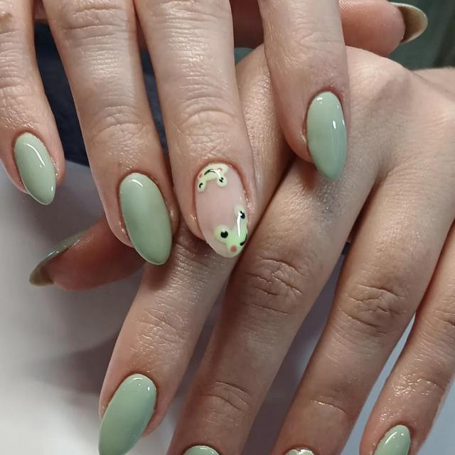 Sage green almond nails with gold flecks
