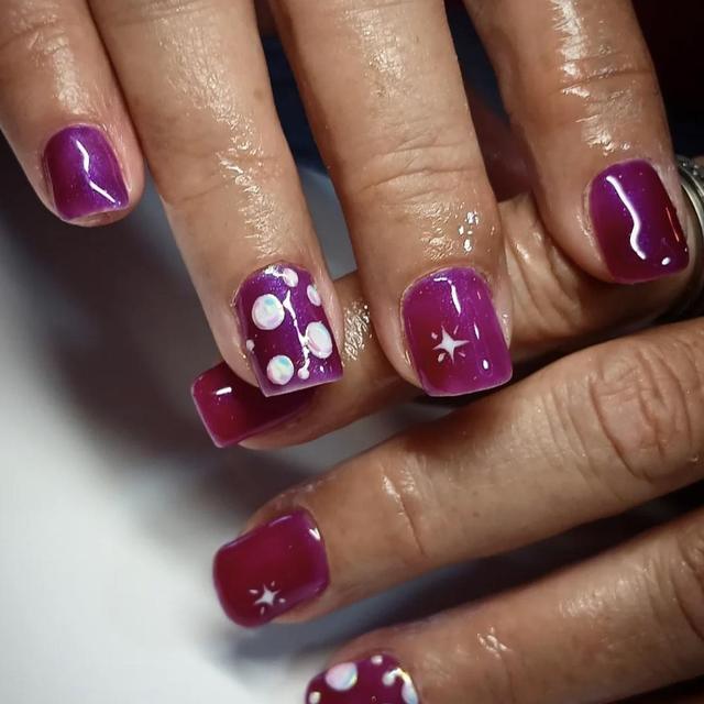 Purple nails with white polka-dot accents